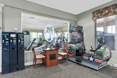 a room with arcade games and machines in it at Bright Resort Home Pool Near Disney in Orlando
