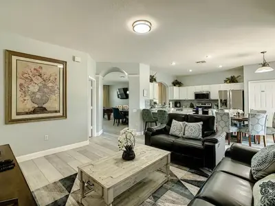 a living room with a couch and a table at Modern 6BR Resort Private Pool Near Disney in Orlando