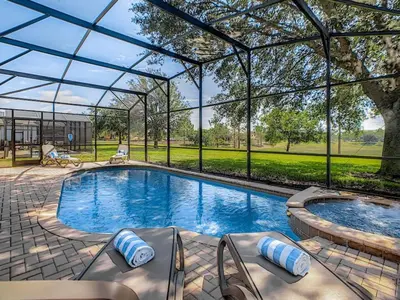 a large swimming pool with a glass roof at Modern 6BR Resort Private Pool Near Disney in Orlando