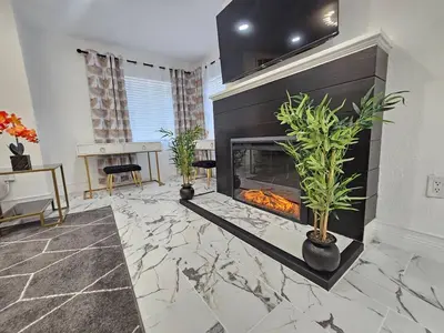 a living room with a fireplace and a table at Stylish Duplex walkTO Lake Eola Orlando. Sleeps 8 in Orlando