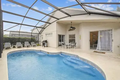 an indoor swimming pool with a glass roof at Casa c/ Piscina Privativa e Game Room in Kissimmee