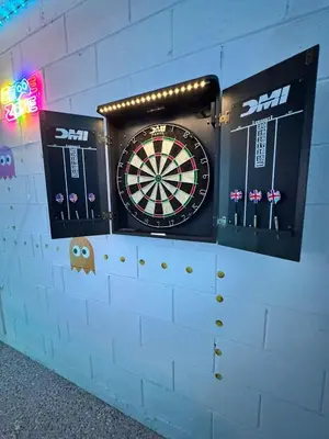 a dart board on a wall with some darts at Casa Kissimmee in Orlando