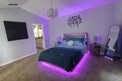 a purple bedroom with a bed with purple lights at Casa Kissimmee in Orlando