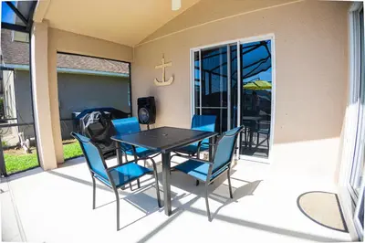 a dining room table and chairs on a patio at Casa Kissimmee in Orlando