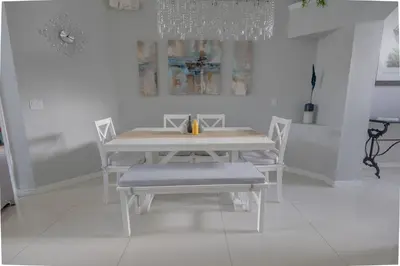 a white dining room with a white table and chairs at Casa Kissimmee in Orlando