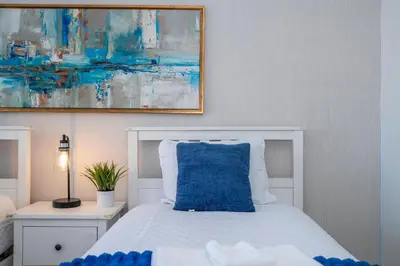 a bedroom with a blue pillow on a bed at Modern 2BR Near Universal in Orlando