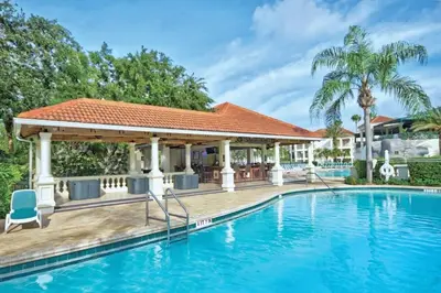 a swimming pool with a gazebo next to a house at Wyndham Star Island Resort-1BR- Apartment with Resort Access in Kissimmee