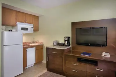 a kitchen with a white refrigerator and a tv at Wyndham Star Island Resort-2BR- Apartment with Resort Access in Kissimmee