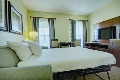 a hotel room with a large bed and a couch at Wyndham Star Island Resort-2BR- Apartment with Resort Access in Kissimmee
