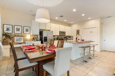 a kitchen and dining room with a table and chairs at 4BR Lake View Home Bella Vida in Kissimmee