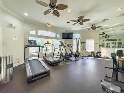 a gym with treadmills and cardio equipment in a room at Elegant Emerald Island – Near Disney in Kissimmee