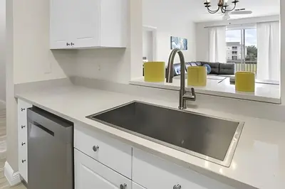 a kitchen with a sink in a white kitchen at Refúgio 3Q no Windsor Palms Resort in Kissimmee
