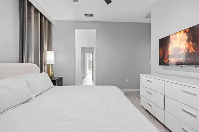 a white bedroom with a bed and a tv at Home 08 Bedrooms At Bella Vida in Kissimmee