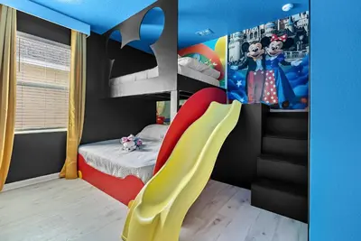 a childs room with a play room with a slide at Home 08 Bedrooms At Bella Vida in Kissimmee