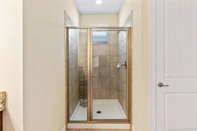 a shower with a glass door in a bathroom at Vila 8Q Disney c/ Piscina, Spa e Bar Temático in Orlando