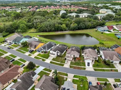 an aerial view of a neighborhood with houses and a lake at 10 min to Disney | Karaoke | Game in Kissimmee