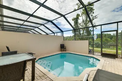 a swimming pool in a house with a glass ceiling at Family-Friendly Resort Getaway 5 Mi to Disney! in Kissimmee