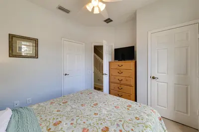 a bedroom with a bed and a dresser at Family-Friendly Resort Getaway 5 Mi to Disney! in Kissimmee