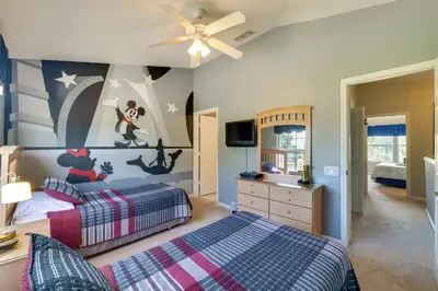 a bedroom with two beds and a ceiling fan at Pool and Resort Perks Family Retreat Near Disney! in Kissimmee