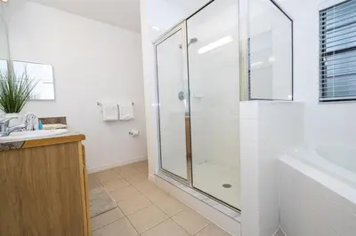 a bathroom with a shower and a sink at 2BR Condo Close to Disney - Gated, Pool & Hot Tub in Kissimmee