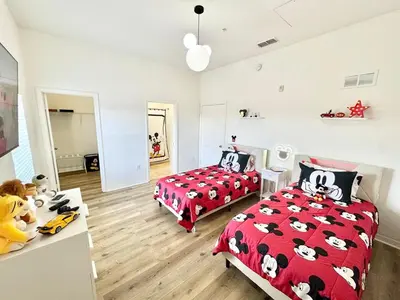 a bedroom with two beds with hello kitty sheets at 2BR Condo Close to Disney - Gated, Pool & Hot Tub in Kissimmee