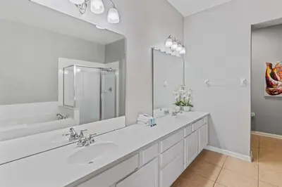a bathroom with two sinks and a large mirror at Amplo Apartamento 4 Quartos no Vista Cay Resort in Orlando