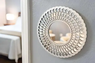 a mirror hanging on a wall with a bedroom at Casa 3Q Moderna c/ Piscina e Clube Resort in Kissimmee