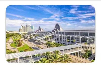 a view of a large building with palm trees and buildings at LuXury Stay | Pool + Gym + Fast Wi-fi in Orlando