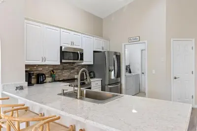 a kitchen with a sink and a counter top at Orlando Family Retreat 4BR, Private Pool and Lake in Kissimmee
