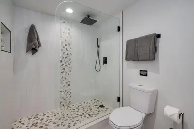 a white bathroom with a shower and a toilet at Orlando Lake View Entire Home-NearDowntown in Orlando