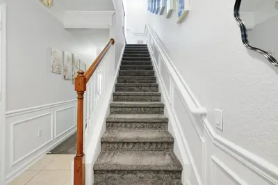 a staircase in a home with white walls at Epic Universe Vacation Townhome, Vista Cay - 4035 in Orlando