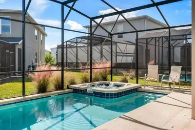 a swimming pool in front of a house at Heated Pool Game Room Waterpark 9MI to Disney in Kissimmee