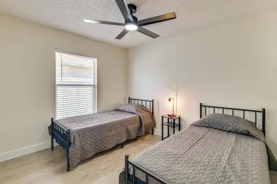 a bedroom with two beds and a ceiling fan at 10 Mi to Animal Kingdom Clermont Home with Pool! in Orlando