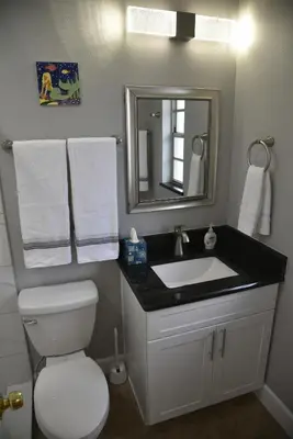a bathroom with a white toilet and a sink at Perfecto Mundo 2, Orlando Area 4BR-2B-Outdoor Pool-Jacuzzi-Billiard in Orlando