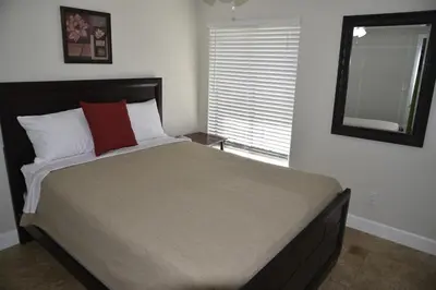 a bedroom with a large bed with a mirror at Perfecto Mundo 2, Orlando Area 4BR-2B-Outdoor Pool-Jacuzzi-Billiard in Orlando