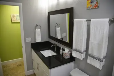 a bathroom with a sink and a mirror and towels at Perfecto Mundo 2, Orlando Area 4BR-2B-Outdoor Pool-Jacuzzi-Billiard in Orlando