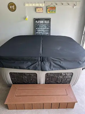 a bed with a black cover on top of it at Perfecto Mundo 2, Orlando Area 4BR-2B-Outdoor Pool-Jacuzzi-Billiard in Orlando