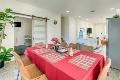 a dining room with a red table and chairs at 5 Mi to Old Town Kissimmee! Family Escape with Perks in Kissimmee