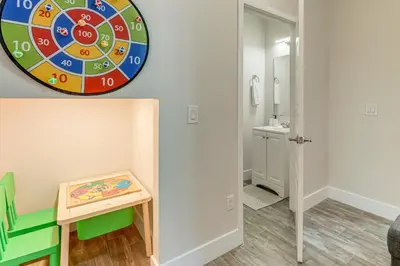 a play room with a dart board on the wall at 5 Mi to Old Town Kissimmee! Family Escape with Perks in Kissimmee