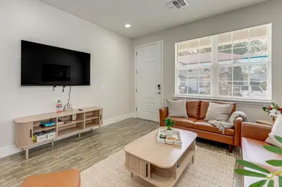 a living room with a couch and a flat screen tv at 5 Mi to Old Town Kissimmee! Family Escape with Perks in Kissimmee