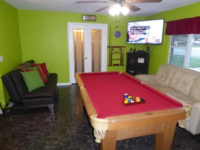 a living room with a pool table and a couch at Perfecto Mundo 4, Orlando Area 4BR-2BA Jacuzzi-Billiard-Ping Pong-City Pool in Orlando