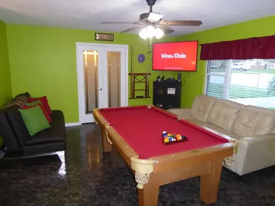 a living room with a pool table and a couch at Perfecto Mundo 4, Orlando Area 4BR-2BA Jacuzzi-Billiard-Ping Pong-City Pool in Orlando