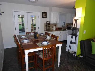 a kitchen with a wooden table with chairs and a dining room at Perfecto Mundo 4, Orlando Area 4BR-2BA Jacuzzi-Billiard-Ping Pong-City Pool in Orlando
