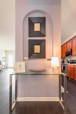 a glass table in a kitchen with a lamp at The Epic Barcelona Penthouse Vista Cay Orlando Florida in Orlando