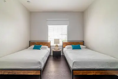 two twin beds in a room with a window at The Epic Barcelona Penthouse Vista Cay Orlando Florida in Orlando