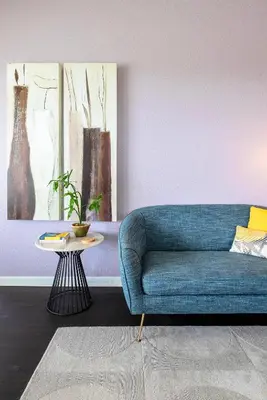 a blue couch in a living room with a table at The Epic Barcelona Penthouse Vista Cay Orlando Florida in Orlando