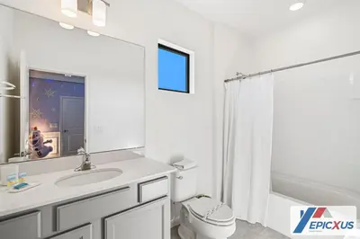 a bathroom with a sink and a toilet and a shower at The Epic Venice Paradiso Grande Orlando Florida in Orlando