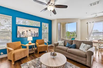 a living room with a couch and chairs at 8805 Dunes Court Unit 5-202 in Kissimmee