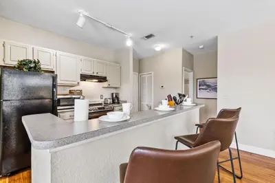 a kitchen with white cabinets and a black refrigerator at 8805 Dunes Court Unit 5-202 in Kissimmee
