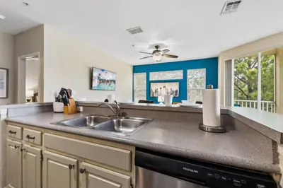 a kitchen with a sink and a counter at 8805 Dunes Court Unit 5-202 in Kissimmee